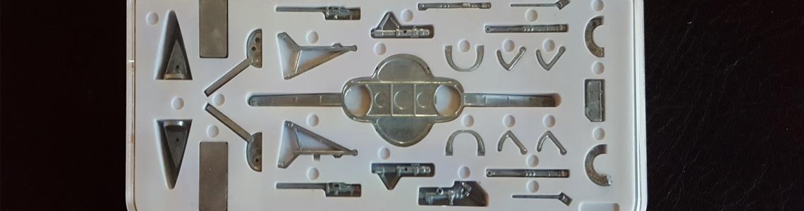 Plastic case containing metal parts included in the kit