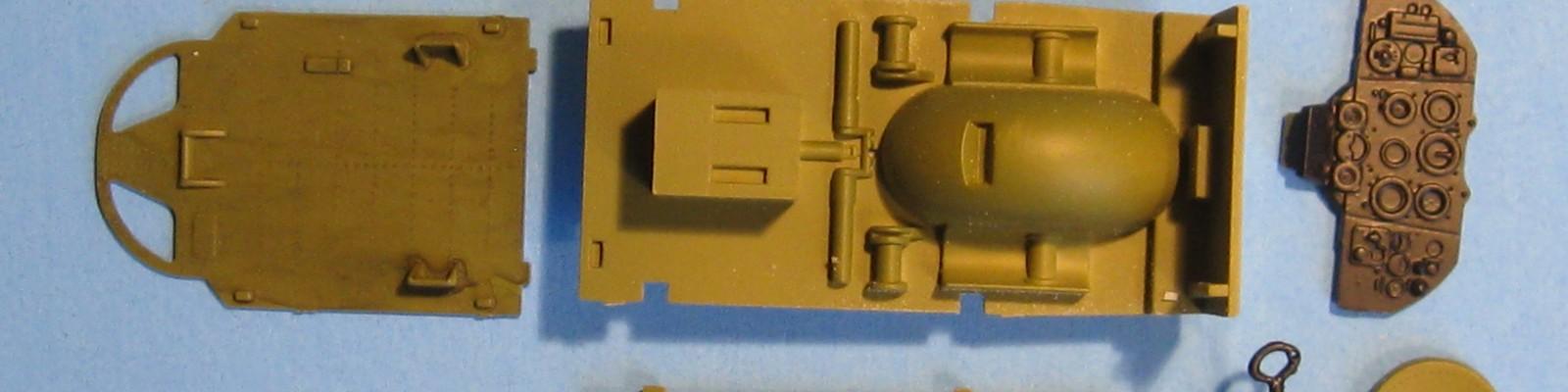 The cockpit “folds” up into a solid little box, with easy detail painting access before assembly.  The top of the wheel well juts up into the cockpit floor.