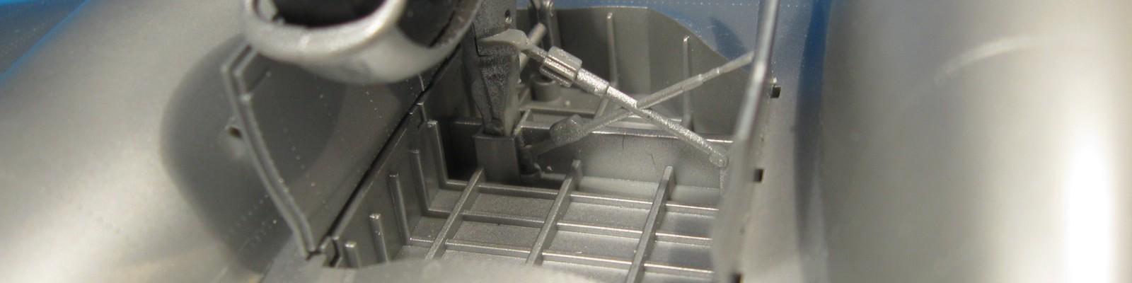 The main gear and well with associated hydraulics, struts and gear compartment covers are shown.