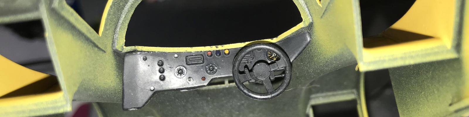 Inside the cab of the car looking toward the dash and steering wheel – the car does not afford much of a view of the interior, so I didn’t spend much effort on sprucing it up