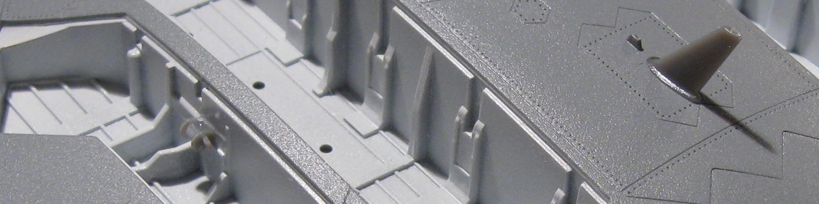 The cover hinge attachment points are solid square sockets in the weapons bay and the gear well.