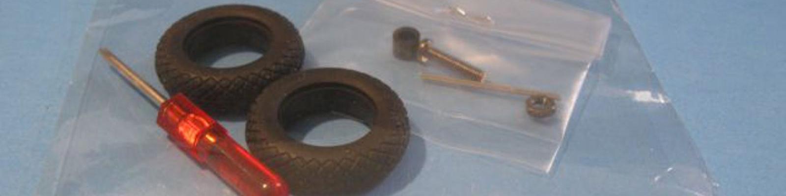 Rubber tires, with a very small Phillips screwdriver with mounting hardware for display stand.