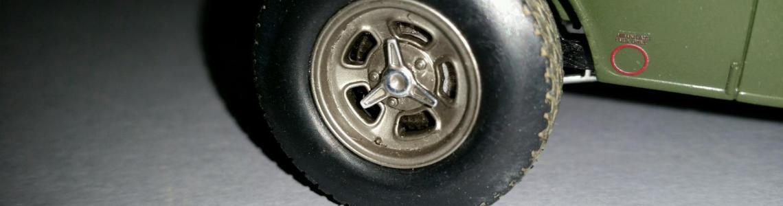 Close-up of weathered tire and Halibrand wheels