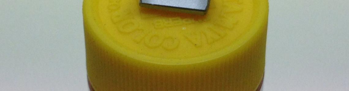 Painted cart on jar to provide scale