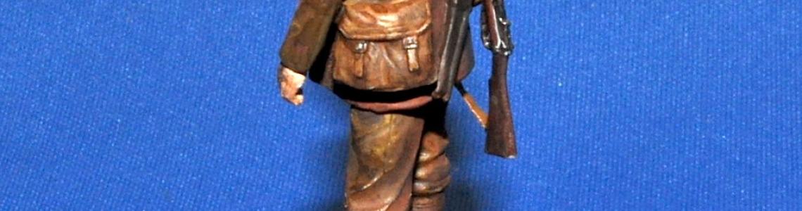 Soldier with slung rifle, back