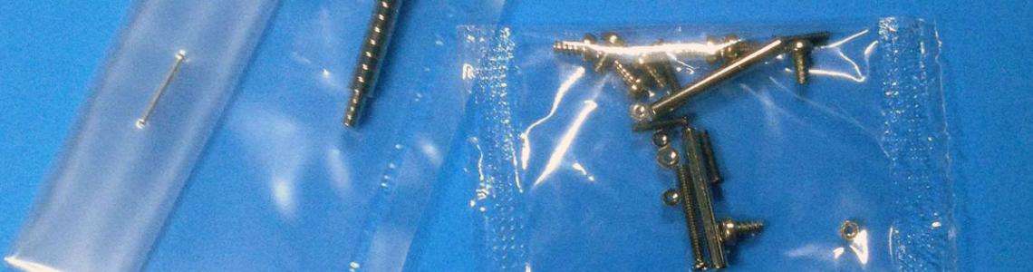 Multi-media materials include some non-traditional components. The screwdriver tip is on a stack of disc-like magnets in two sizes. The screws, nuts, and bolts are used in construction and the magnets are applied to the flame dampers on the exhaust pipes and the radiators. The screwdriver is 2 inches long.