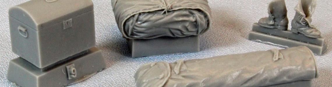 Trunk, boots, folded tent, long canvas sack.