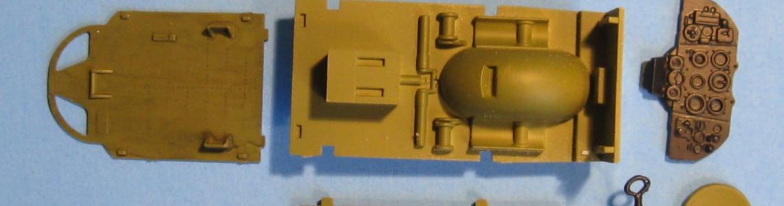 The cockpit “folds” up into a solid little box, with easy detail painting access before assembly.  The top of the wheel well juts up into the cockpit floor.