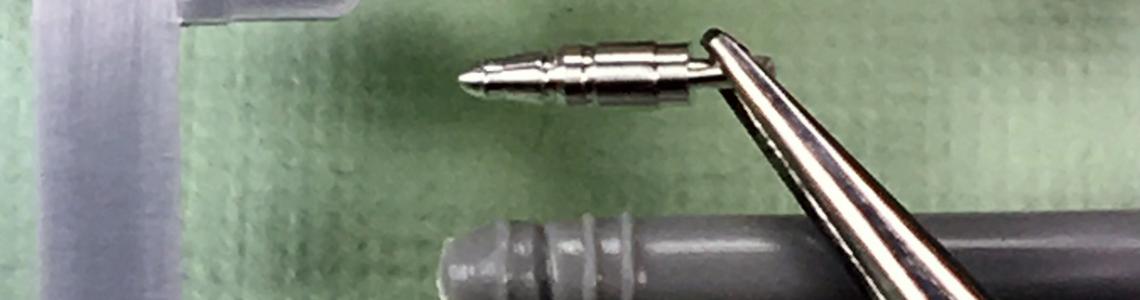 Comparison of the refuelling-probe of the kit part (green) to the Master Model metal part (held with tweezers).