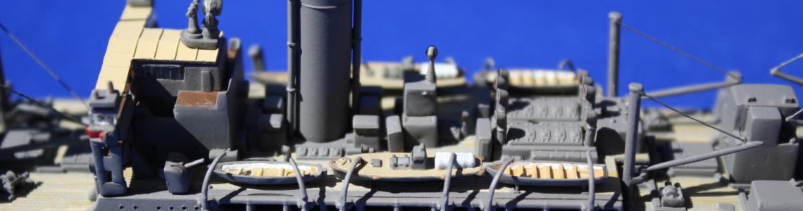 Close-up of amidships boat deck, open funnel, sanded hull with brass rod replacements for external piping