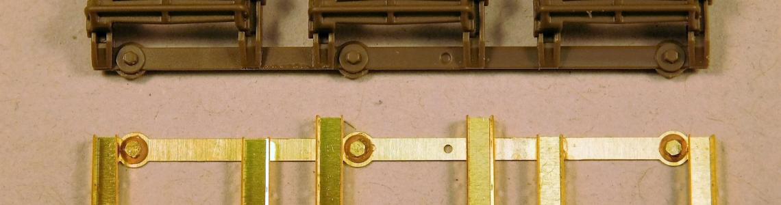Comparison of photo-etch track cleat holders (bottom) versus kit-supplied part (top)