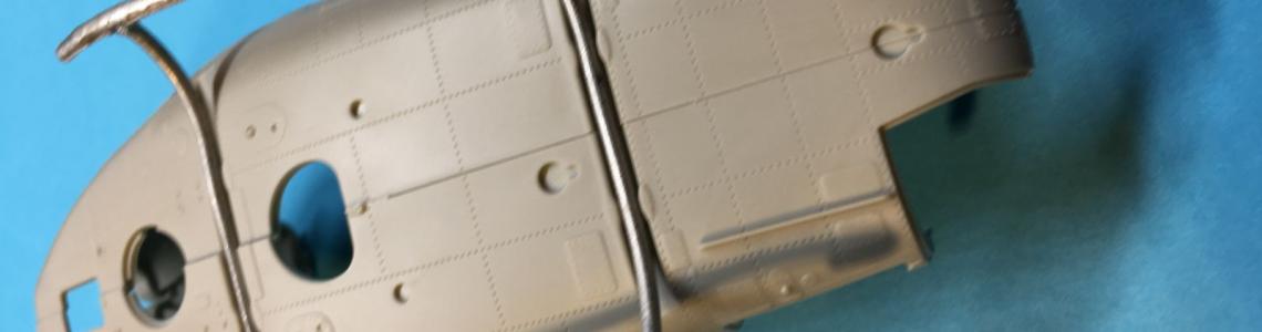 A stand-alone assembly fitted to the fuselage bottom; note that the steps are mounted on the forward skid tips.