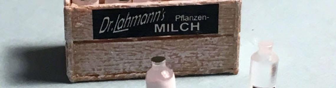 German version of product, assembled and painted as one full milk bottle, one uncapped, almost empty bottle