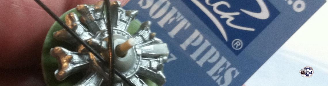 Soft pipes draped over a partly painted 1/48 SNJ engine, fingers for scale
