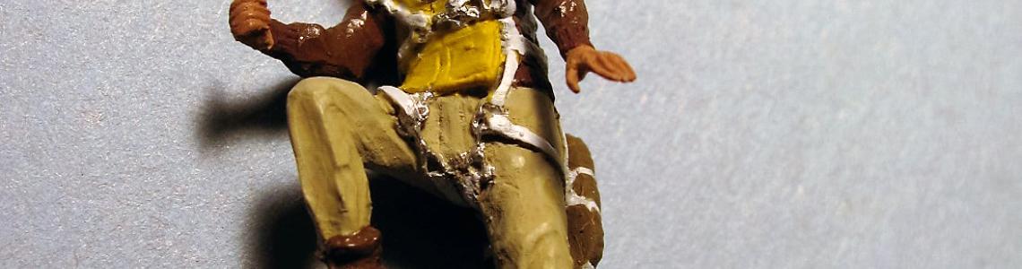 Figure with leather-brimmed hat, side-front