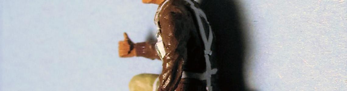 Figure with leather-brimmed hat, side