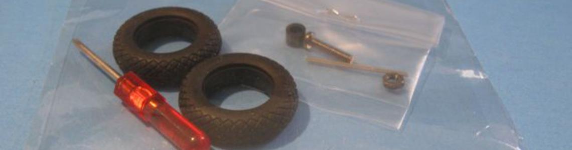 Rubber tires, with a very small Phillips screwdriver with mounting hardware for display stand.
